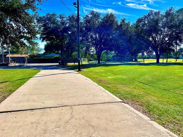 8766 Beauxart Garden Rd, Beaumont, TX 77705 - view of property's community with fence and a yard