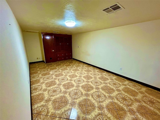 8766 Beauxart Garden Rd, Beaumont, TX 77705 - unfurnished bedroom with a textured ceiling, visible vents, and baseboards