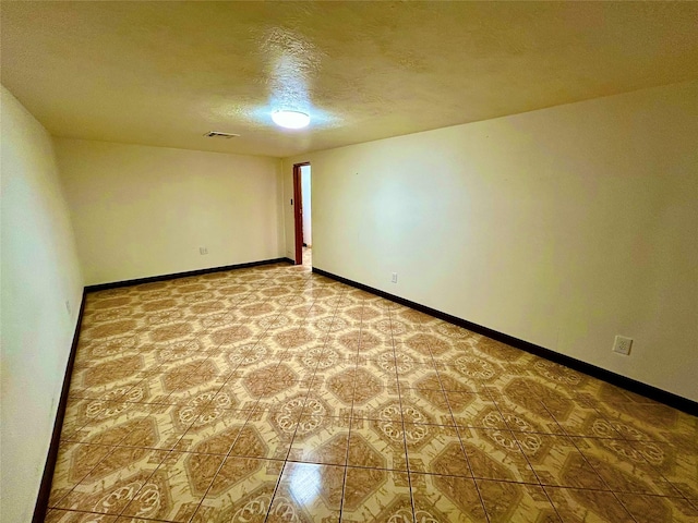 8766 Beauxart Garden Rd, Beaumont, TX 77705 - spare room featuring baseboards, a textured ceiling, and visible vents