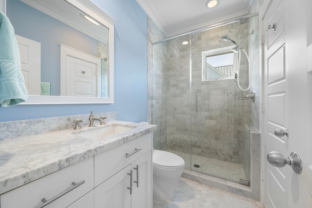 bathroom featuring vanity, toilet, an enclosed shower, and ornamental molding