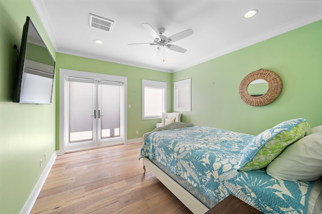 bedroom featuring light wood-type flooring, ceiling fan, and ornamental molding