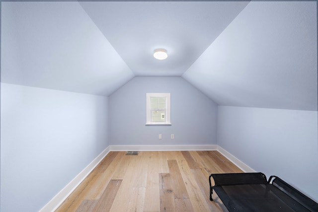 bonus room with light hardwood / wood-style flooring and vaulted ceiling
