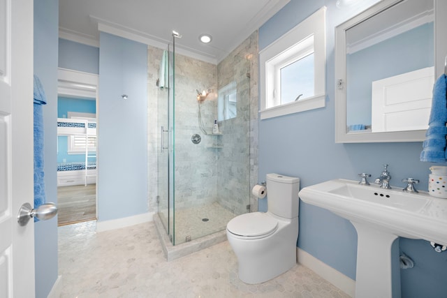 bathroom with ornamental molding, toilet, a shower with shower door, and sink
