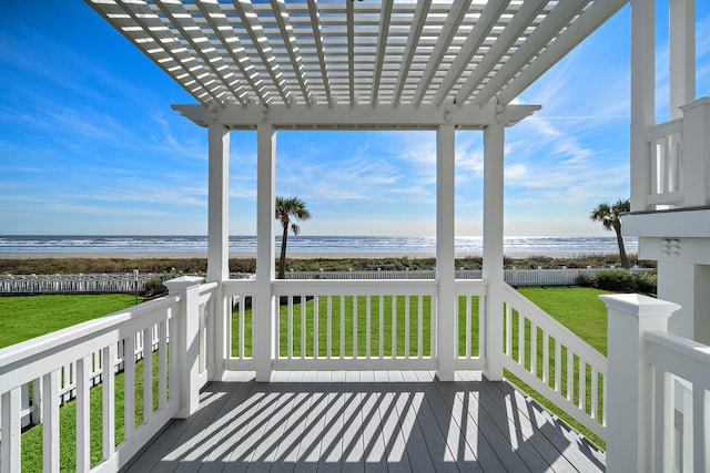 wooden deck featuring a view of the beach, a pergola, and a water view