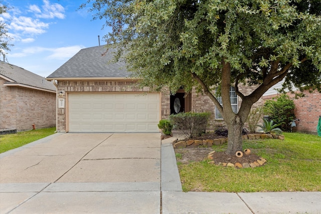 view of front of house featuring a garage and a front lawn