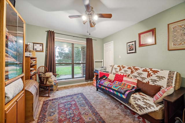 carpeted living room with ceiling fan