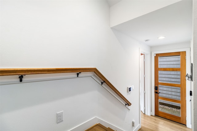 stairs featuring hardwood / wood-style flooring