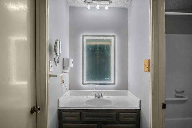 bathroom with vanity and a textured ceiling