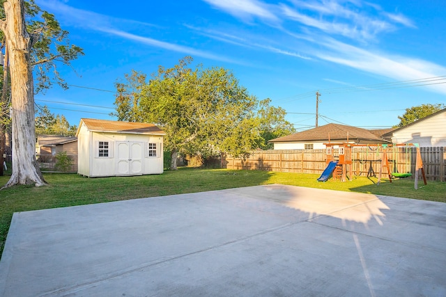 view of patio featuring a playground and a storage shed