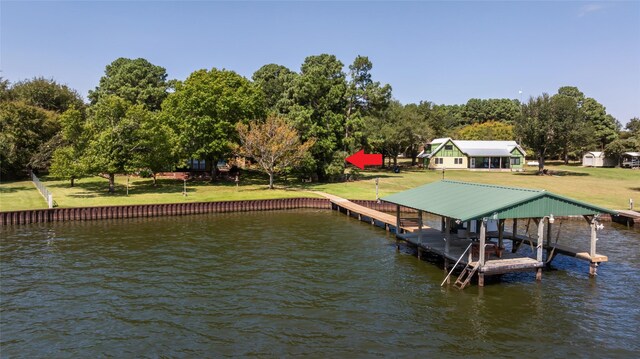 view of dock with a water view and a lawn