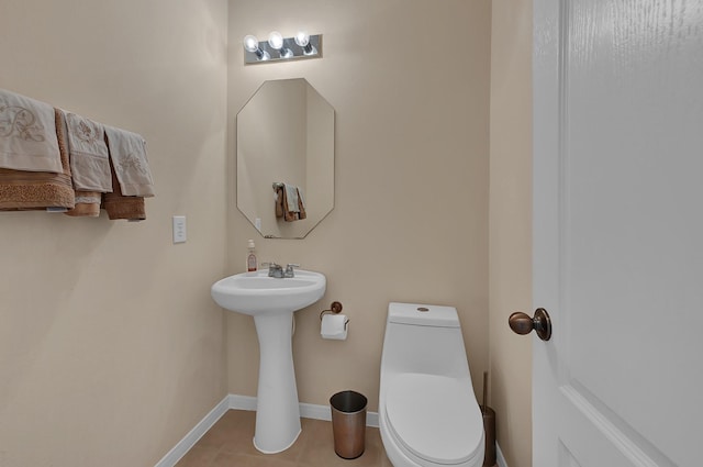 bathroom with tile patterned flooring, toilet, and sink