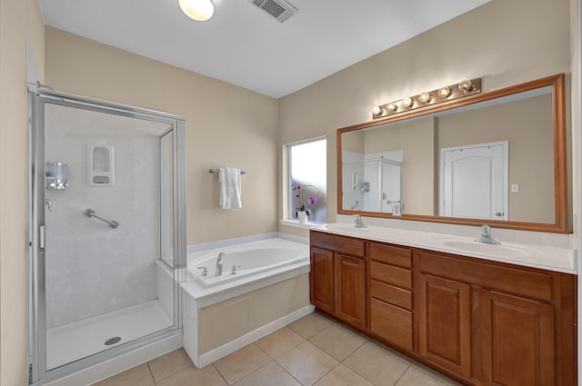 bathroom featuring tile patterned flooring, vanity, and shower with separate bathtub