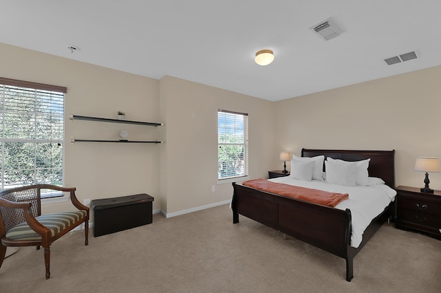 carpeted bedroom featuring multiple windows