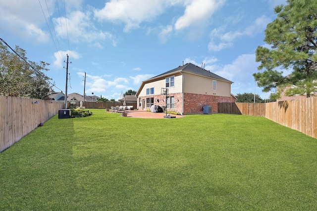 view of yard with central AC unit and a patio