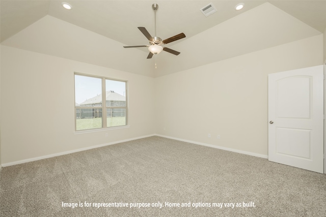 carpeted empty room with ceiling fan and lofted ceiling