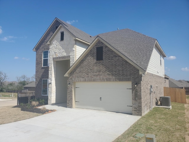 view of front of home featuring a garage, concrete driveway, brick siding, and a shingled roof