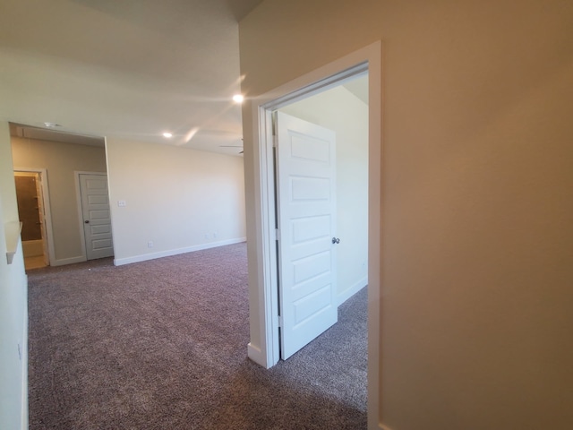 carpeted spare room with baseboards