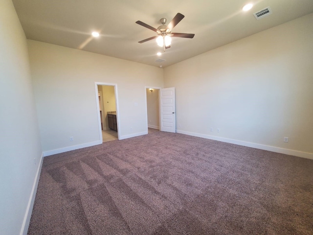 unfurnished bedroom featuring baseboards, visible vents, a ceiling fan, light colored carpet, and ensuite bath