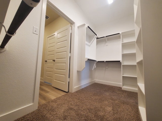 walk in closet with carpet floors and visible vents