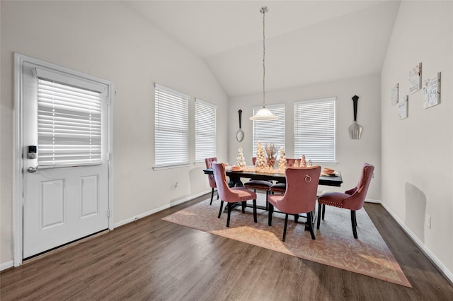 dining room with vaulted ceiling and dark wood-type flooring