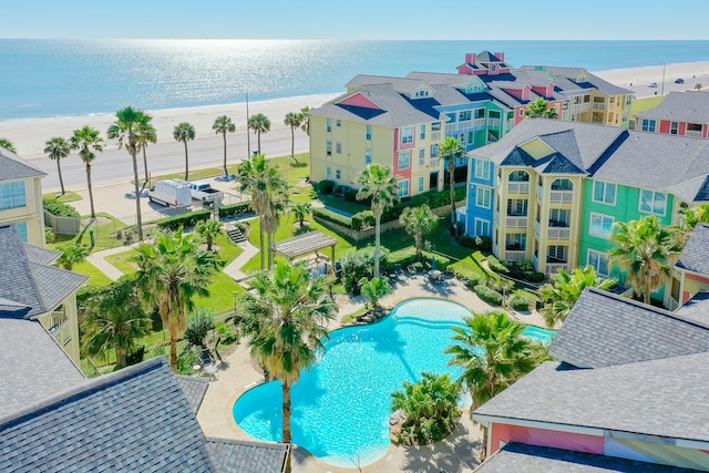 drone / aerial view featuring a beach view and a water view