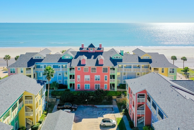 drone / aerial view featuring a water view and a view of the beach