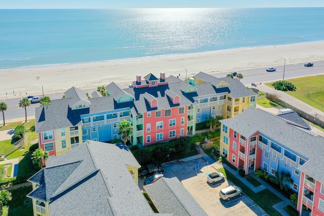 aerial view with a water view and a beach view