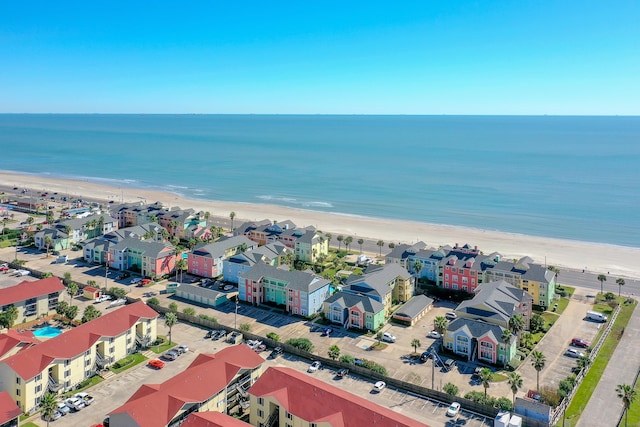 bird's eye view featuring a water view and a beach view