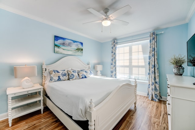 bedroom with hardwood / wood-style floors, ceiling fan, and crown molding