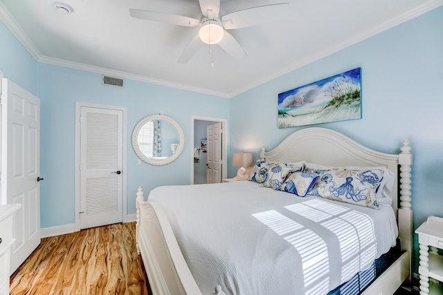 bedroom with light hardwood / wood-style floors, ceiling fan, and ornamental molding