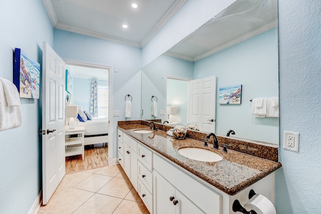 bathroom featuring tile patterned flooring, vanity, and ornamental molding