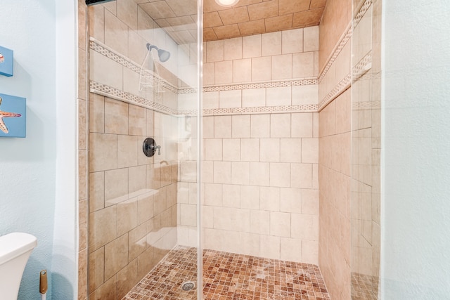 bathroom featuring an enclosed shower and toilet