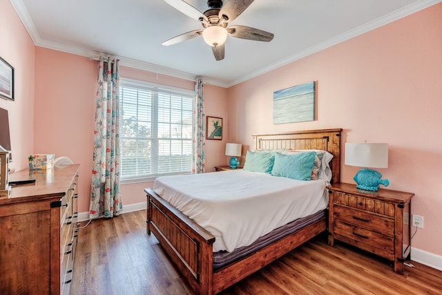 bedroom with hardwood / wood-style flooring, ceiling fan, and ornamental molding