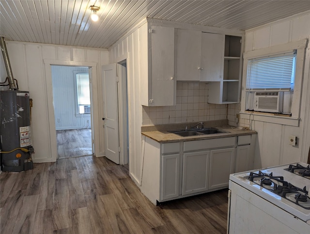 kitchen with white gas range, sink, water heater, dark hardwood / wood-style floors, and white cabinets