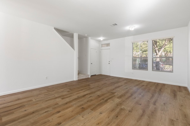 spare room featuring wood-type flooring