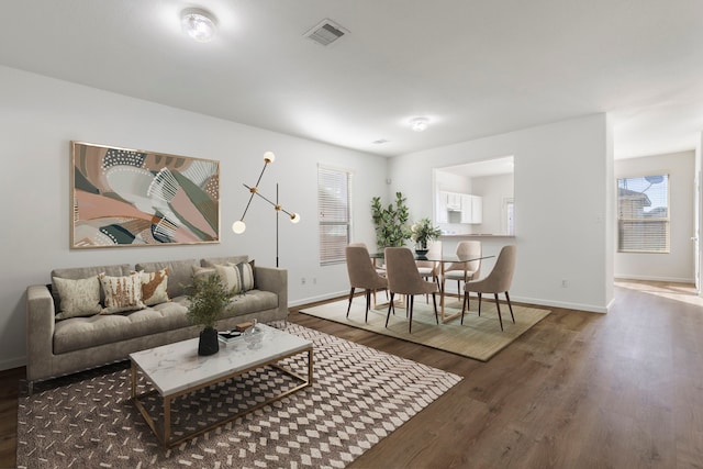 living room featuring dark hardwood / wood-style flooring and a chandelier