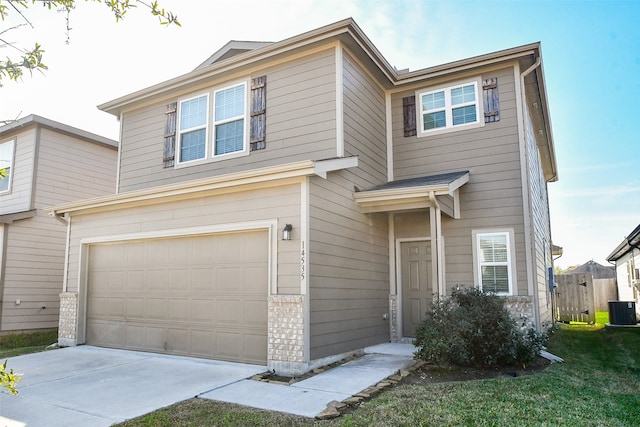 view of front of home featuring central air condition unit and a garage