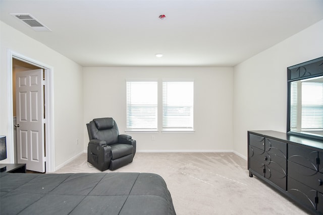 bedroom with light carpet and multiple windows