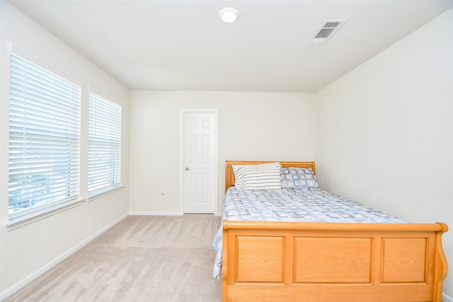 carpeted bedroom featuring multiple windows