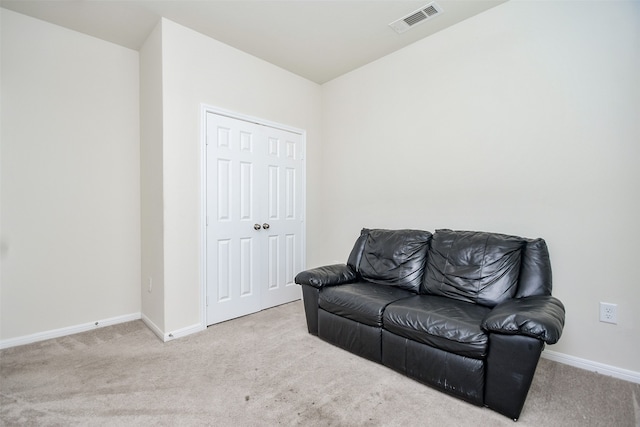 sitting room featuring light carpet