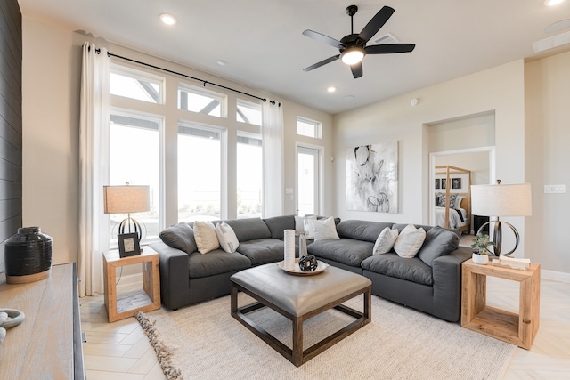 living room featuring light parquet floors, plenty of natural light, and ceiling fan