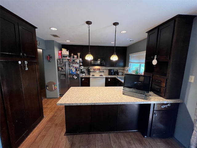 kitchen with kitchen peninsula, light hardwood / wood-style flooring, electric range, decorative light fixtures, and stainless steel fridge with ice dispenser