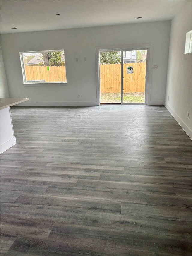 unfurnished room with dark wood-type flooring