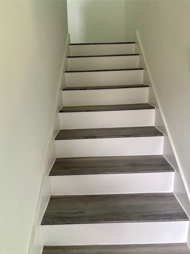 staircase with wood-type flooring