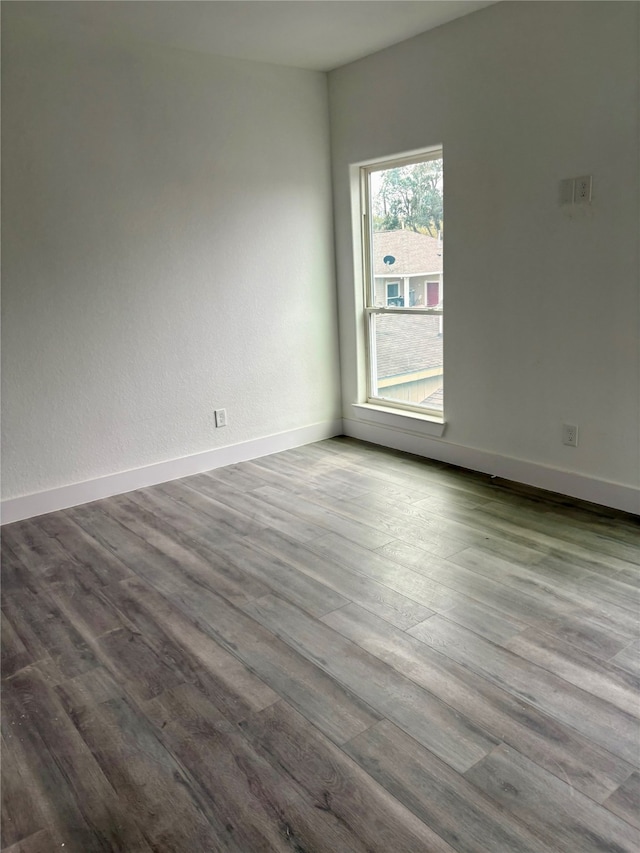 spare room featuring wood-type flooring