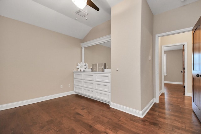 unfurnished bedroom with dark hardwood / wood-style flooring, vaulted ceiling, and ceiling fan