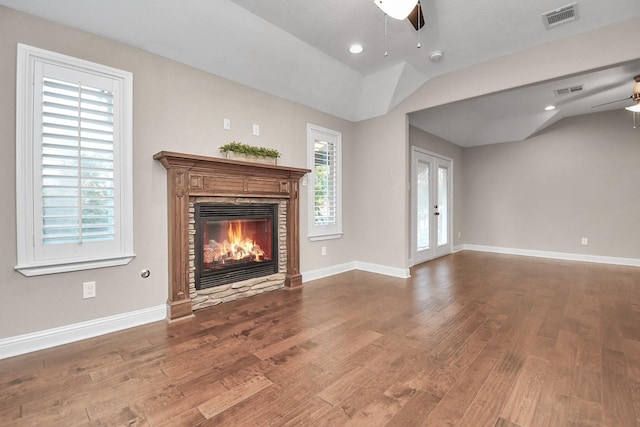 unfurnished living room featuring wood-type flooring, french doors, ceiling fan, and a healthy amount of sunlight