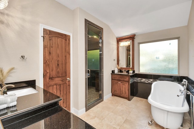 bathroom featuring tile patterned flooring, vanity, vaulted ceiling, and shower with separate bathtub