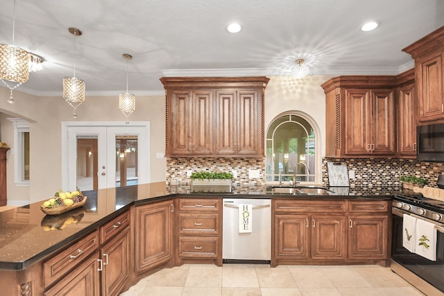 kitchen with appliances with stainless steel finishes, dark stone counters, crown molding, sink, and pendant lighting