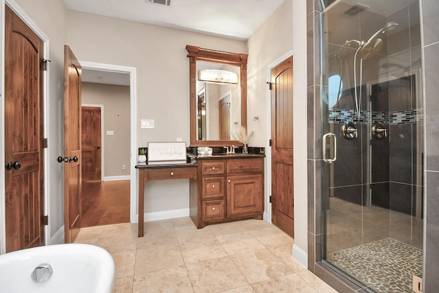 bathroom with tile patterned floors, vanity, and shower with separate bathtub